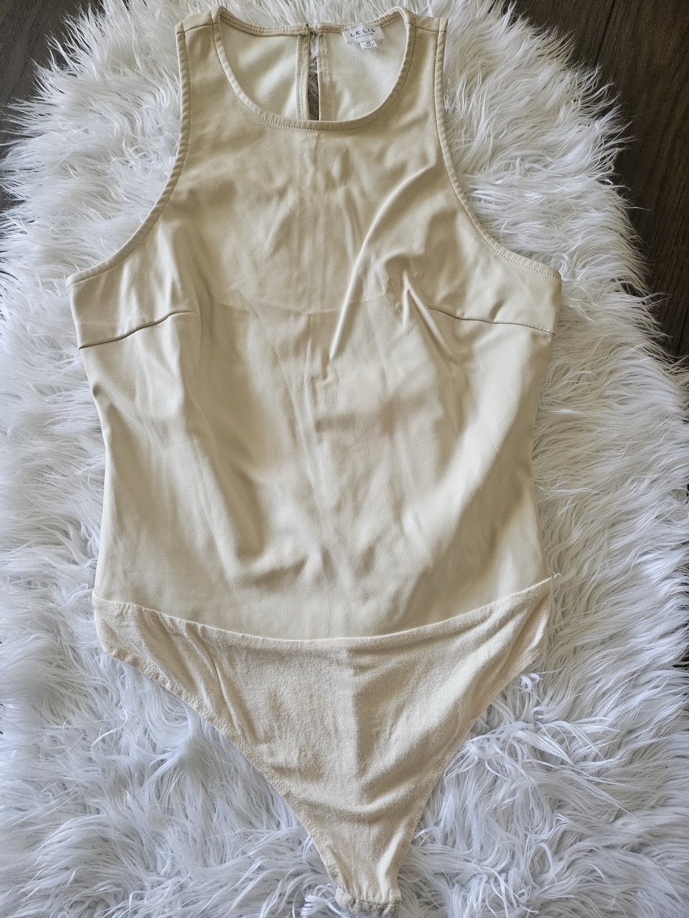 Le Lis Sleeveless High-Neck Faux Leather Bodysuit in Cream